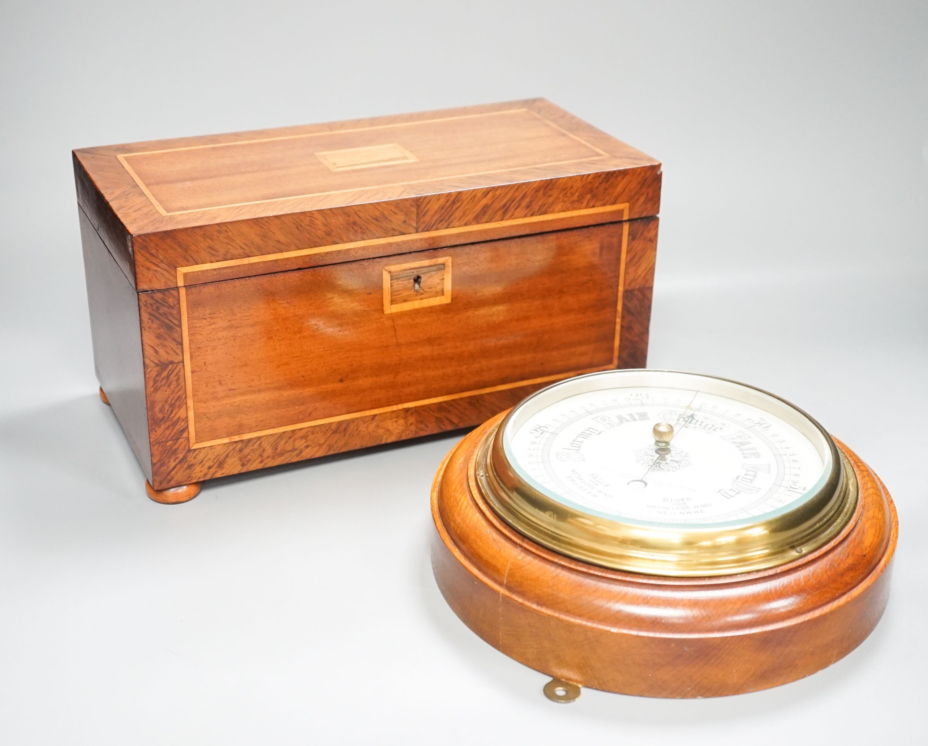 An aneroid barometer in circular polished oak surround and a banded and inlaid two section tea casket, 30.5 x 16.5cm